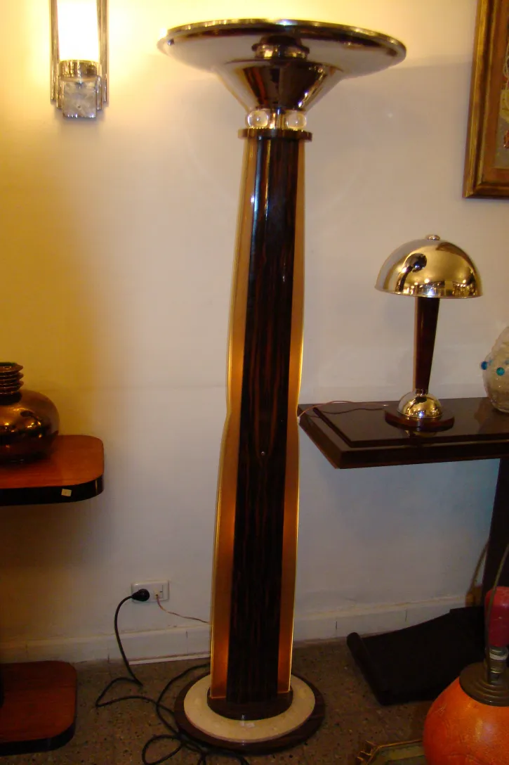 two antique floor lamps with elegant designs in a classic setting.