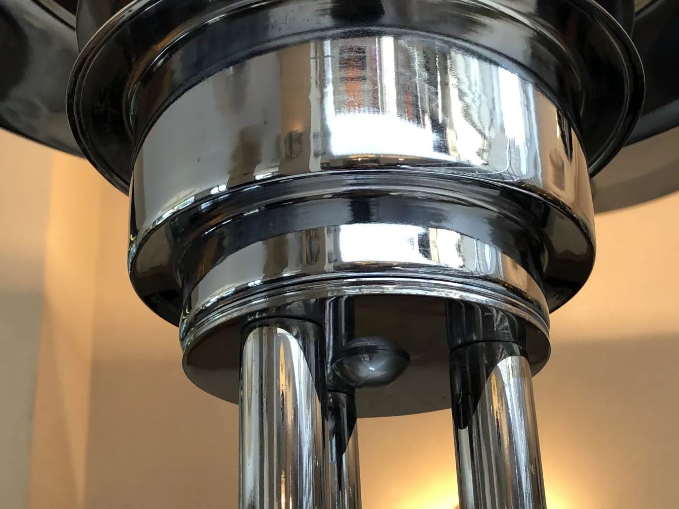 two antique floor lamps with shiny surfaces and elegant shapes in a cozy setting