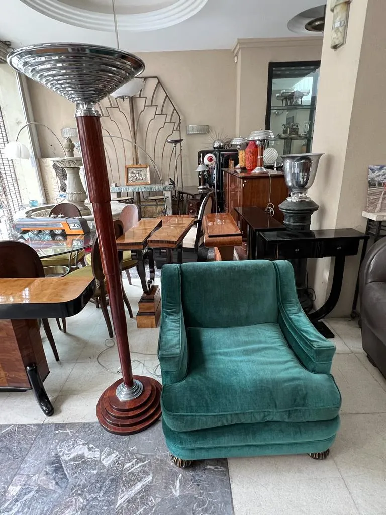 Two antique floor lamps with wooden bases and elegant design in a cozy setting