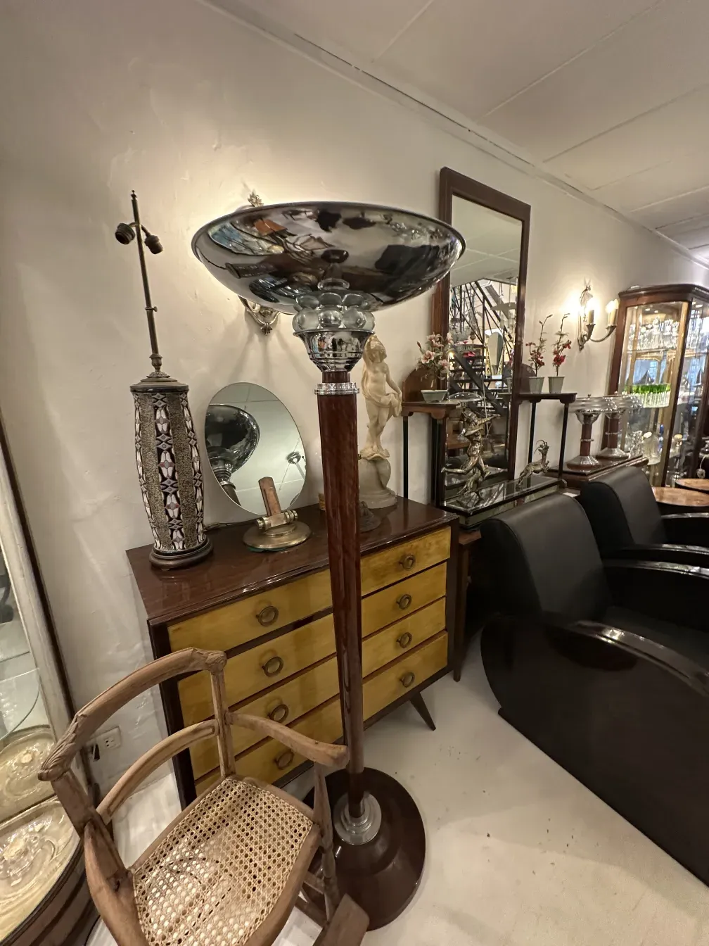 Two antique floor lamps next to a yellow dresser