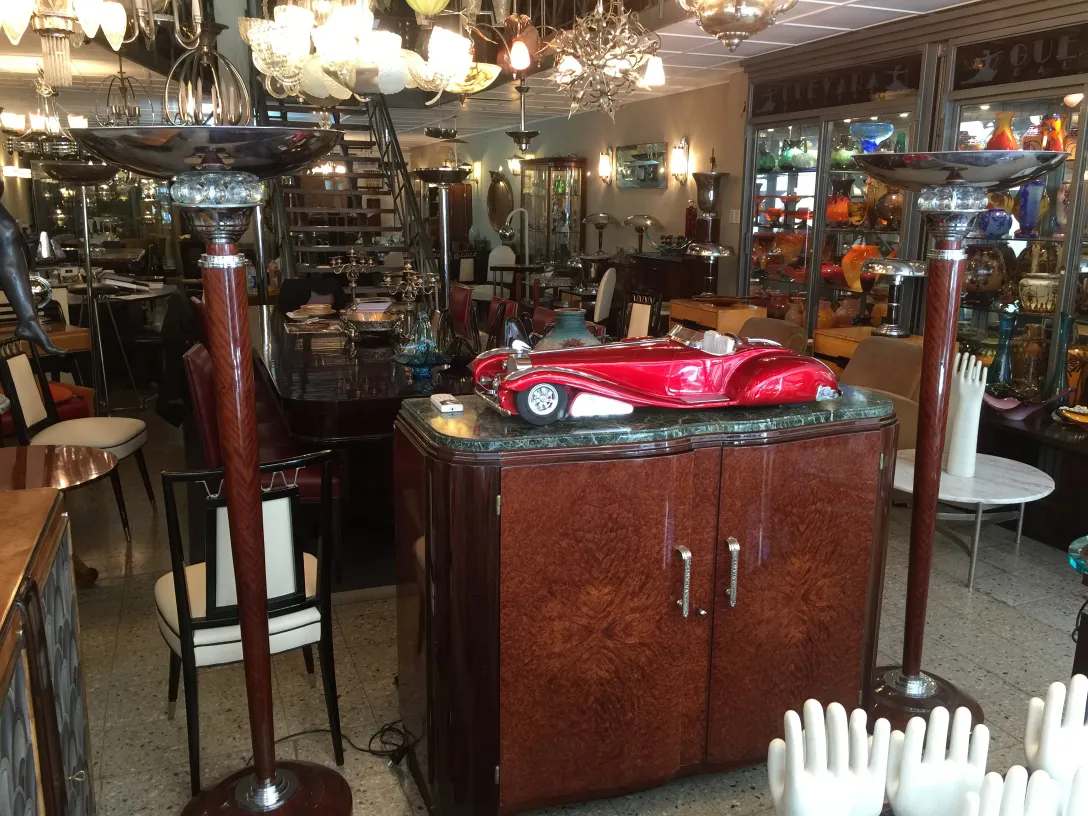 Two antique floor lamps in a classic setting with varied furniture.