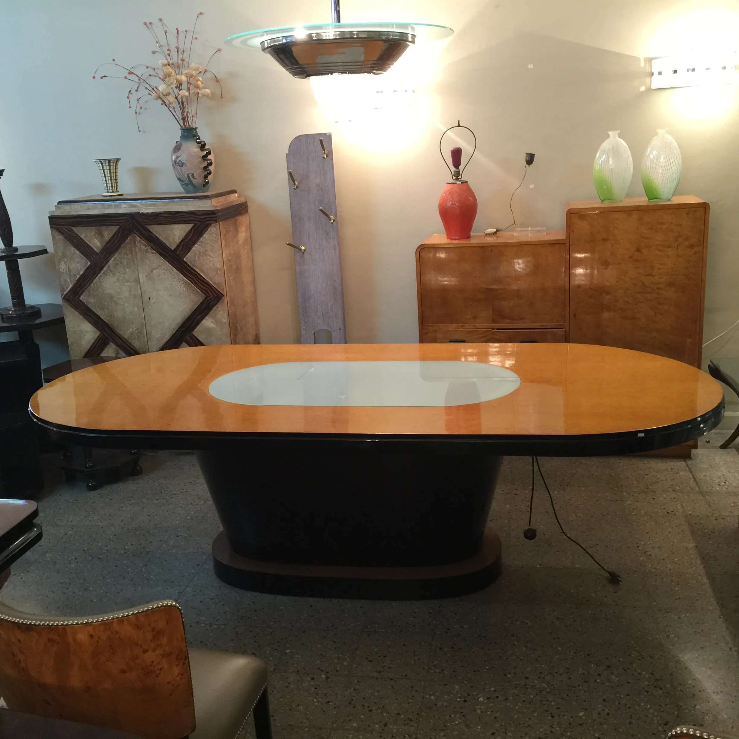 antique art deco dining table, oval shape, with light, elegant setting