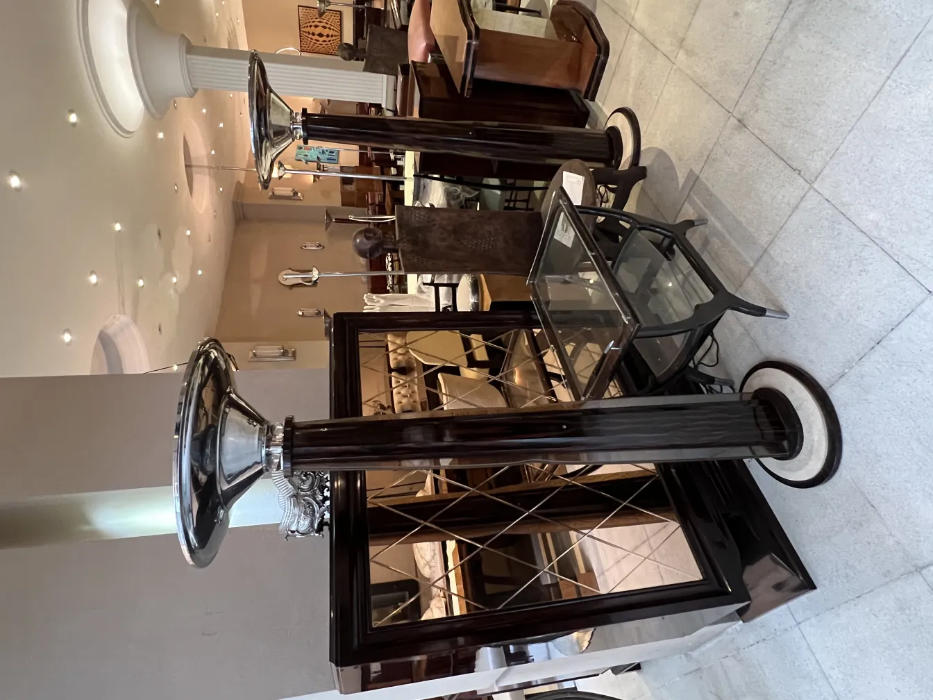 2 antique floor lamps in an elegant setting, featuring decorative details