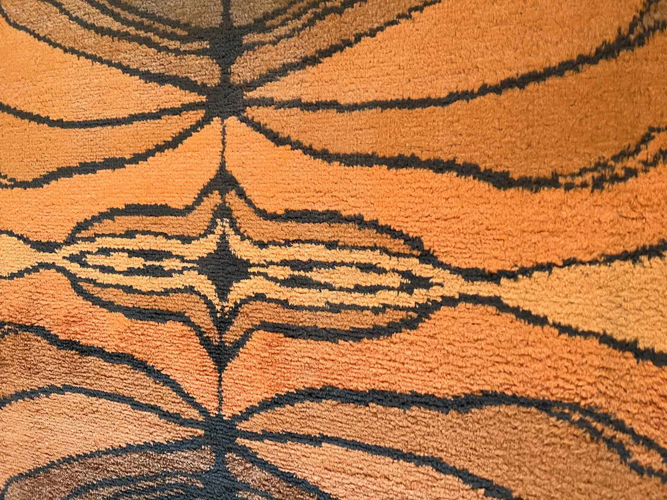 antique carpet with warm and dark tone designs