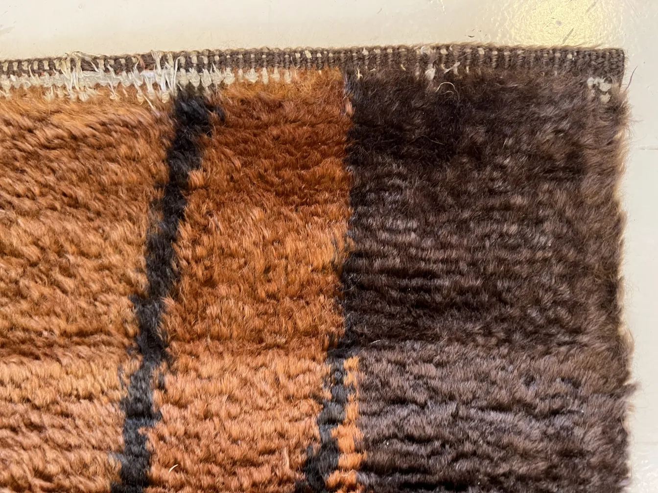 antique carpet with brown and black patterns