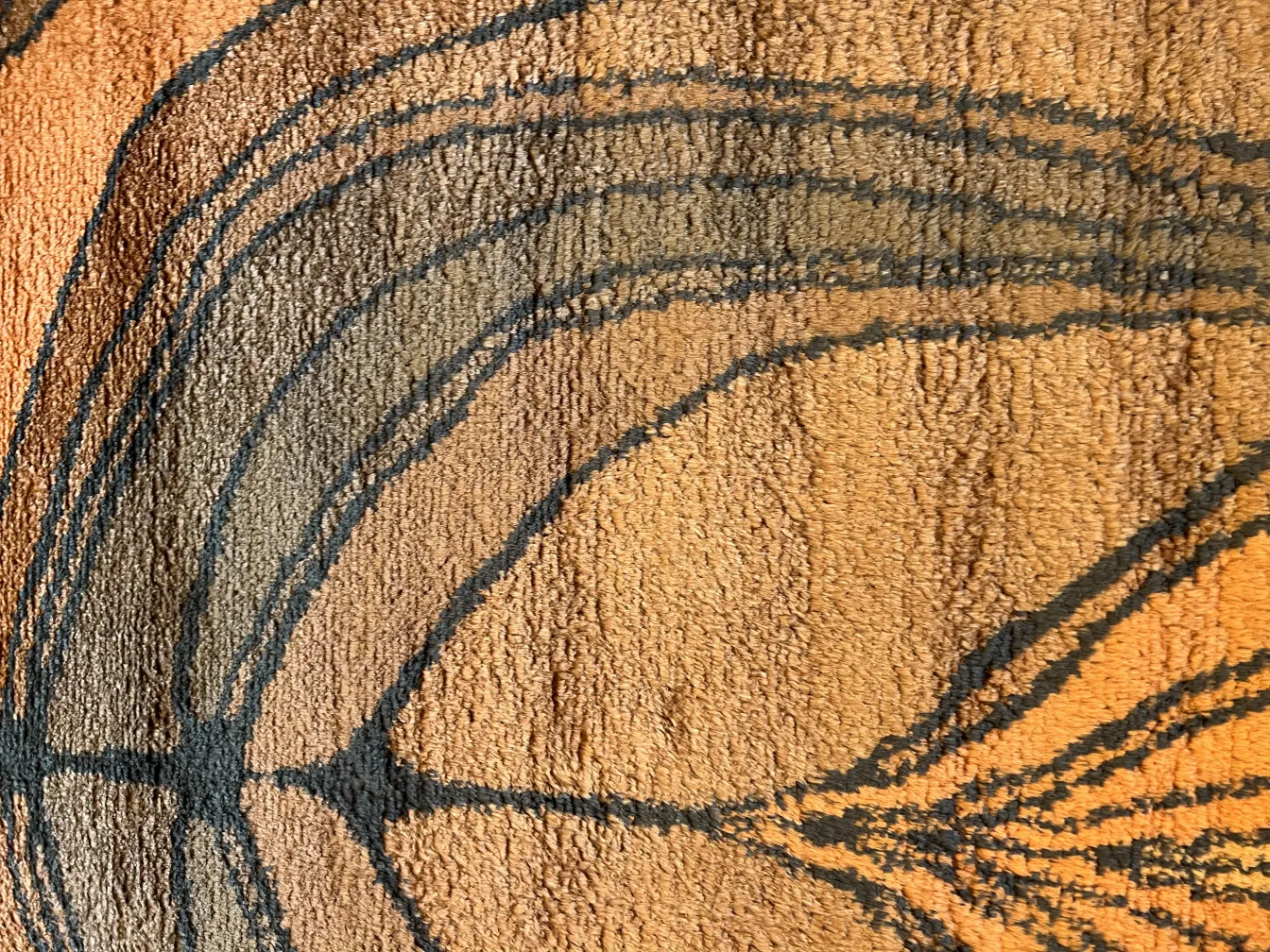 tapis ancien avec des couleurs chaudes et des motifs doux