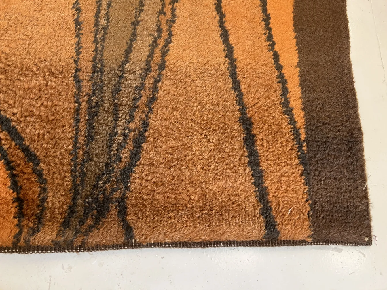 antique carpet with a soft texture and brown-orange design
