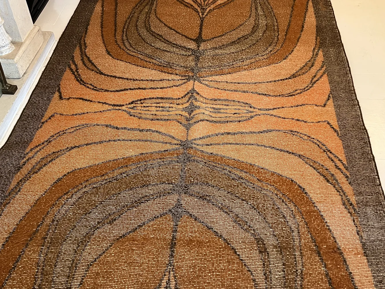 antique carpet featuring beautiful brown and beige geometric patterns in a cozy environment