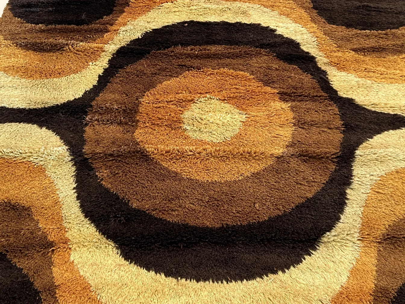 antique carpet with brown and yellow circular patterns