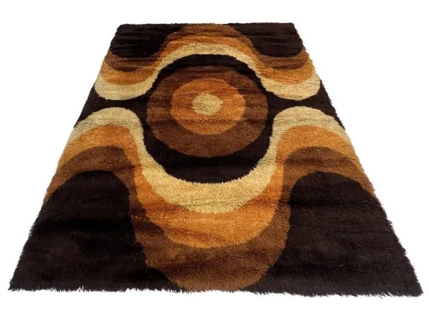Antique carpet with wavy designs in brown and beige tones