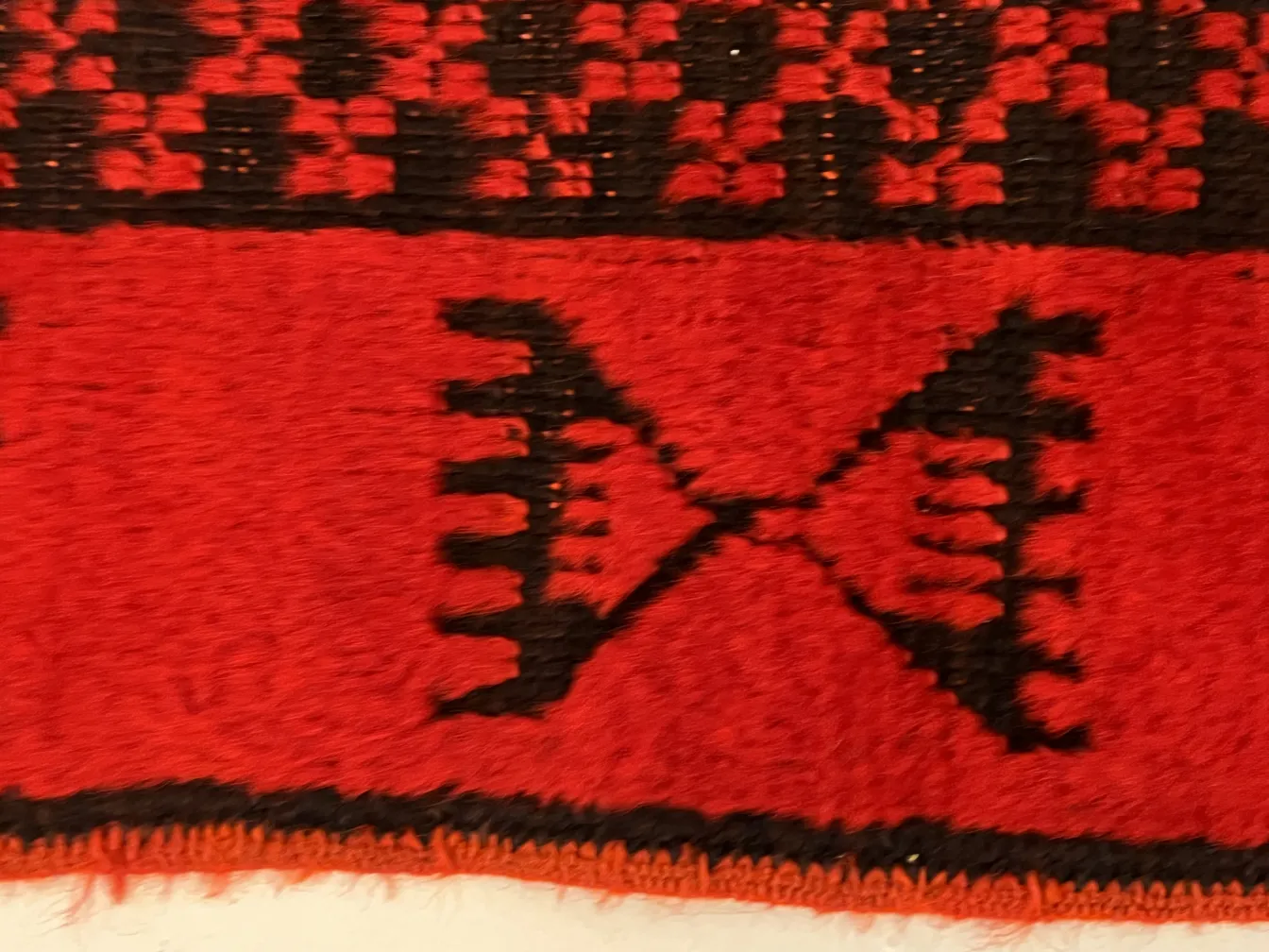 antique red carpet with black geometric patterns