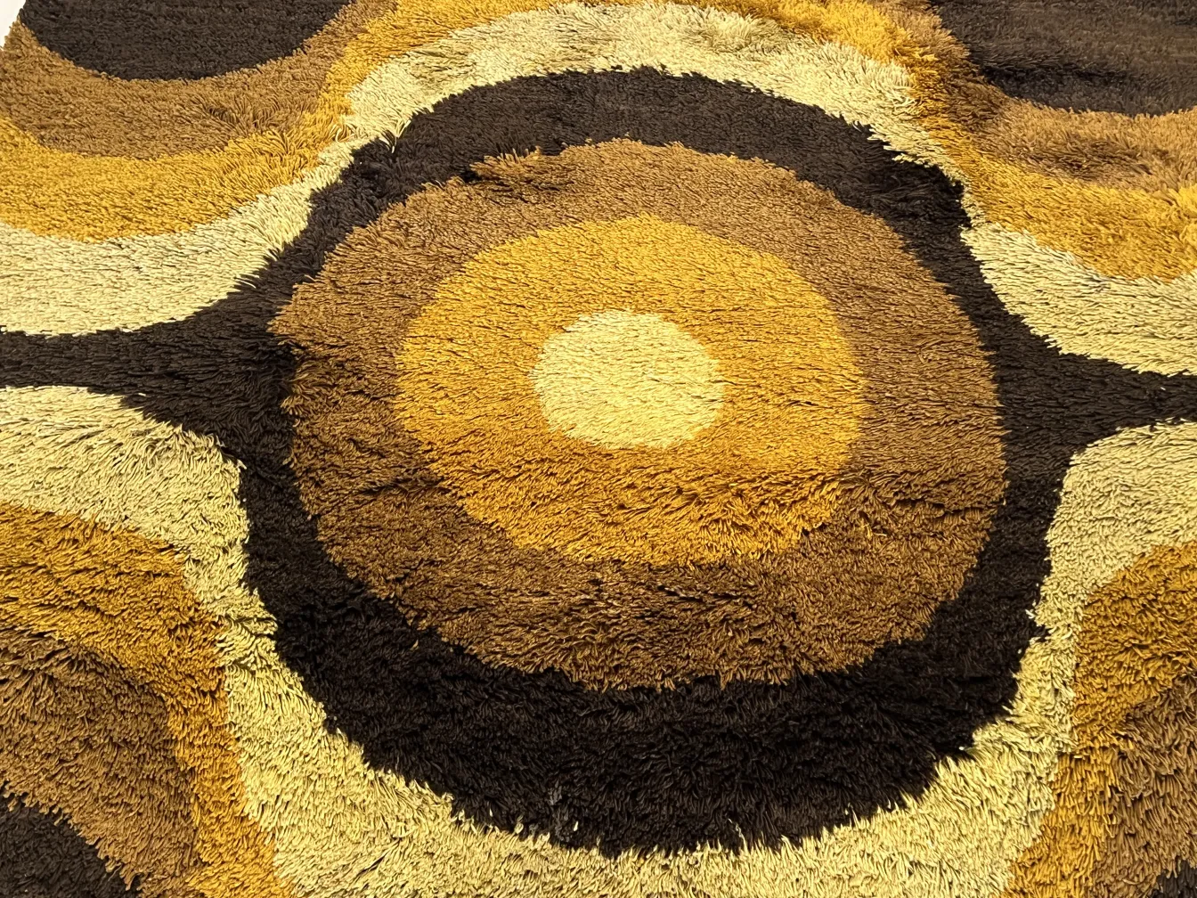 antique carpet with circular design in brown and beige tones
