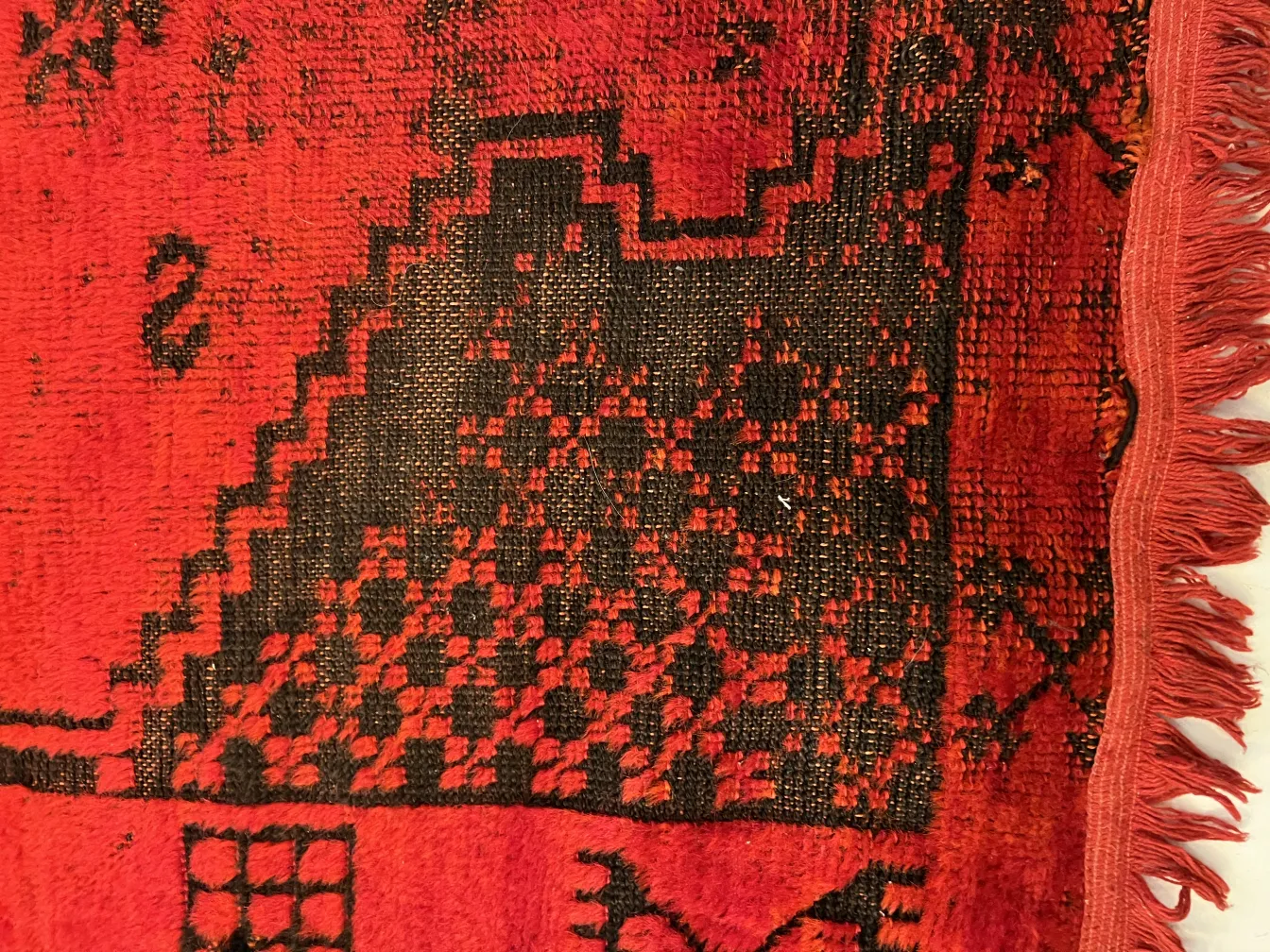 ancient red and black carpet with intricate designs