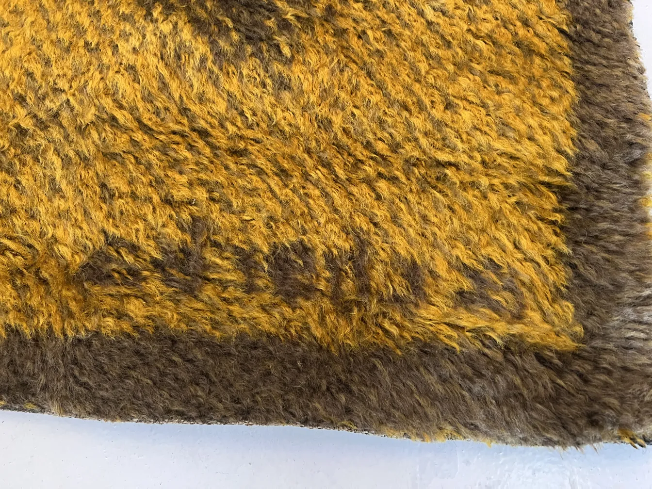 antique carpet with brown and yellow tones, soft texture