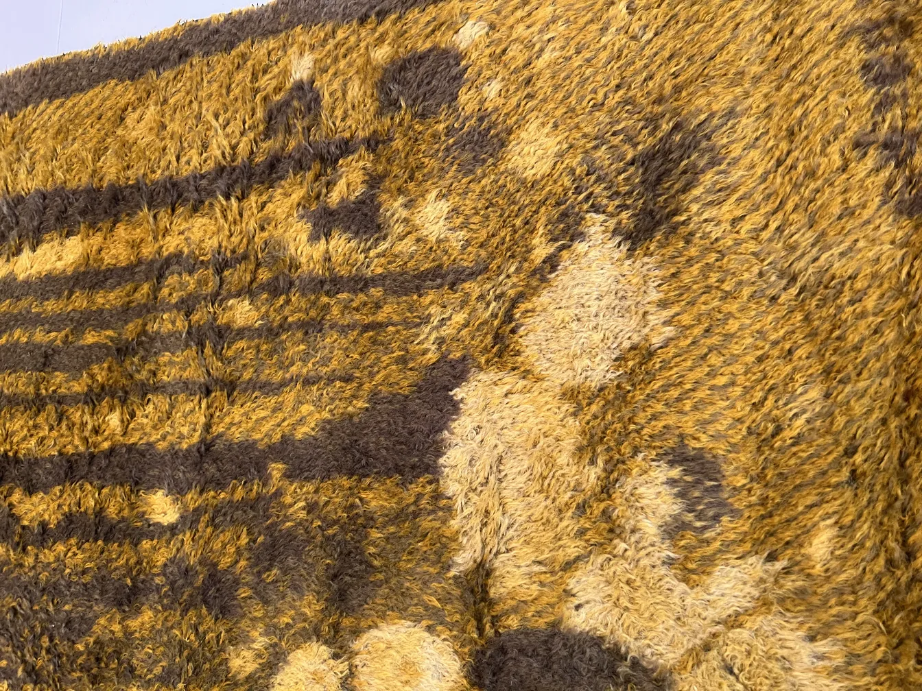 antique carpet with brown and yellow patterned texture