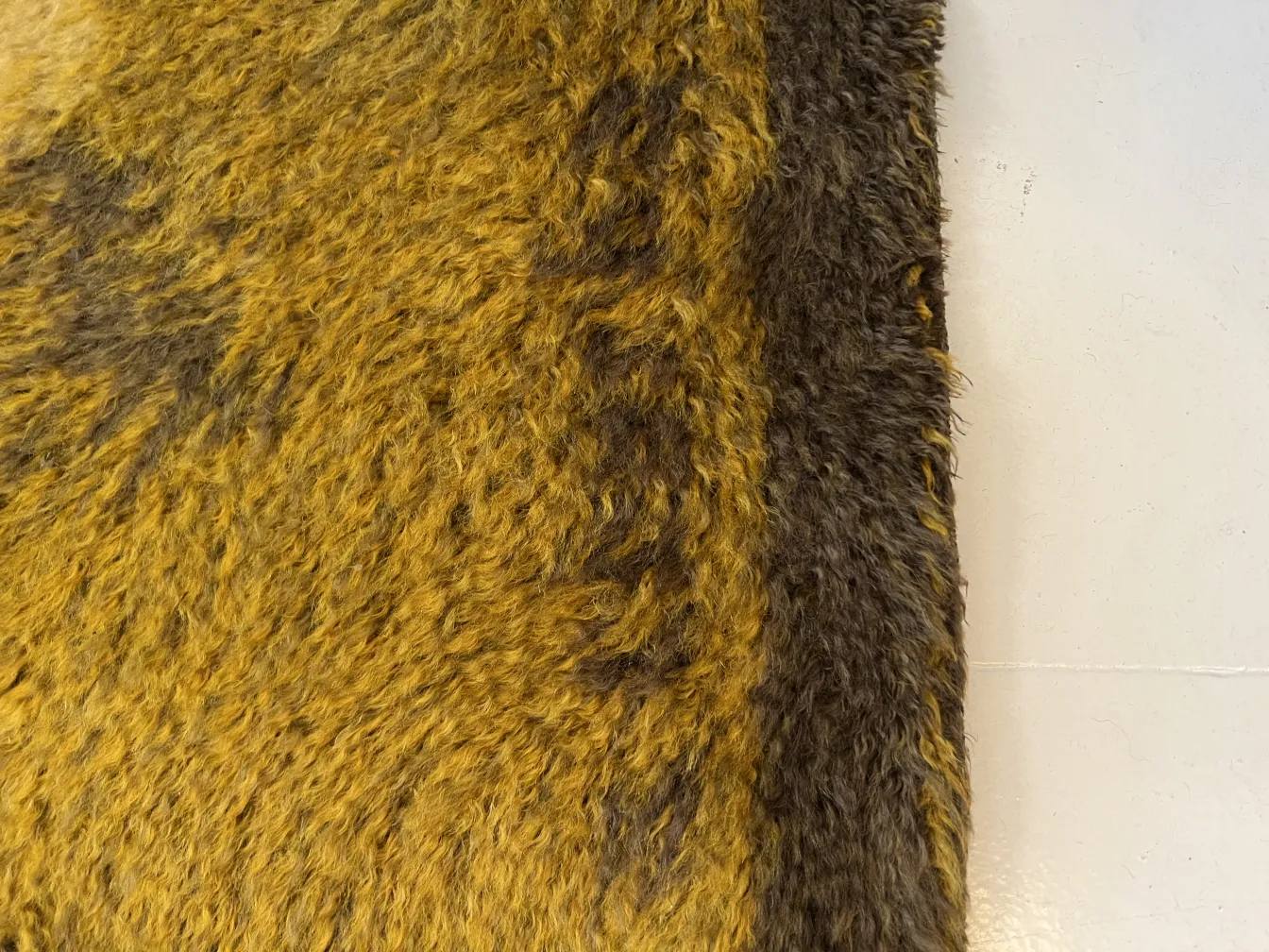 antique carpet featuring soft textures in warm tones