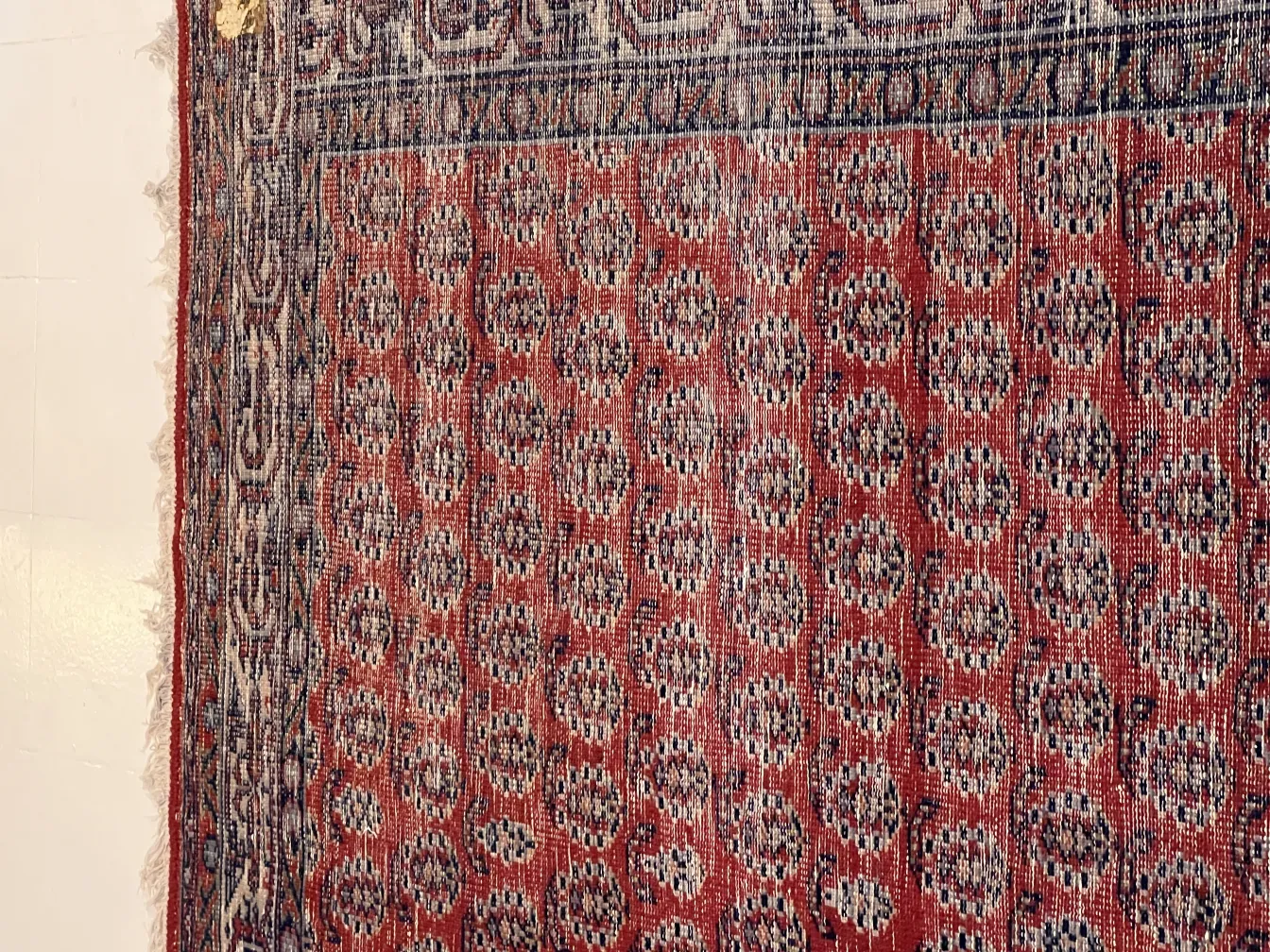 antique carpet showcasing geometric patterns in warm tones
