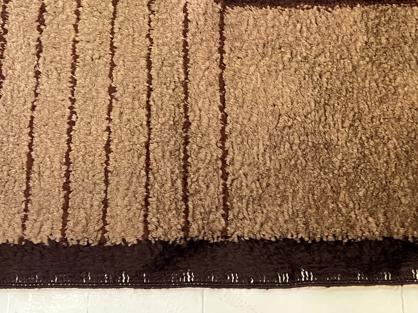 antique long pile carpet with soft patterns and brown colors