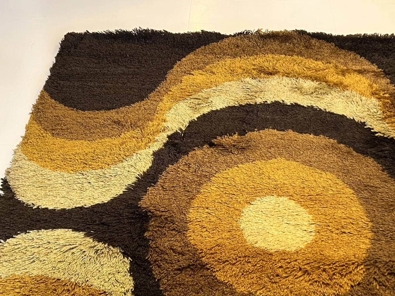 antique carpet with circular design in brown and yellow shades