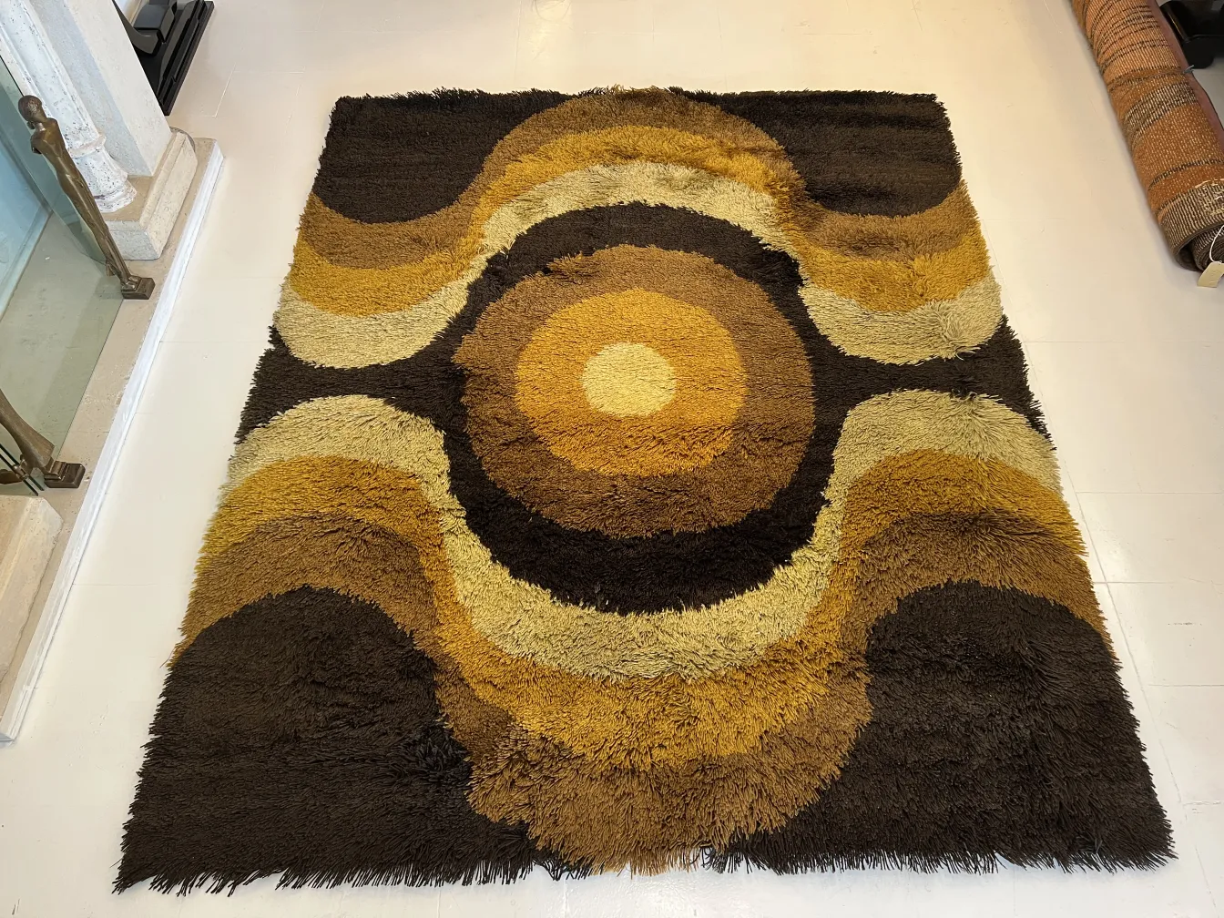 antique carpet with wavy design in brown and yellow hues