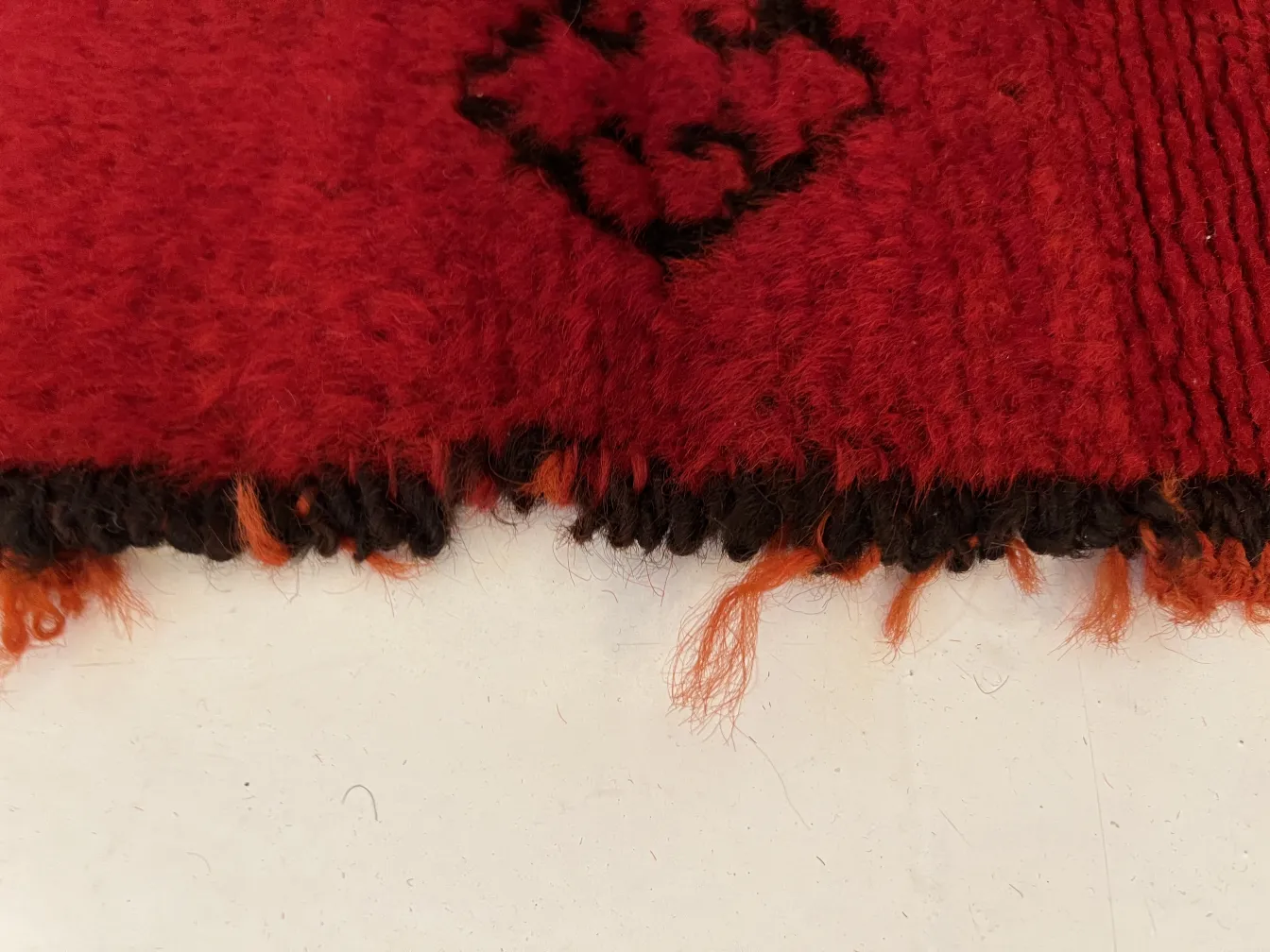 antique carpet with red and black pattern, cozy setting