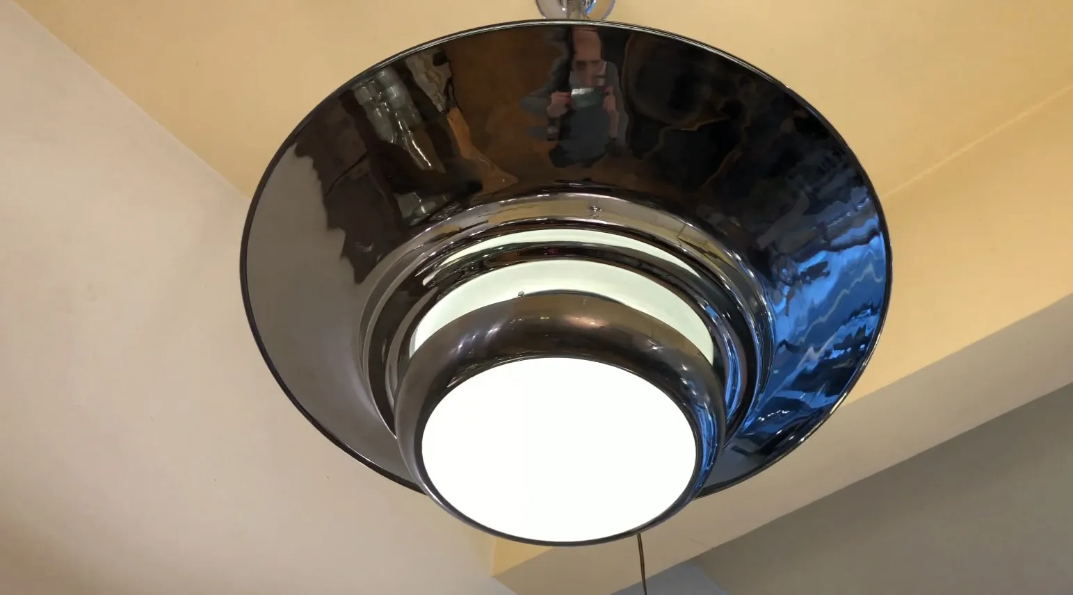 Top view of 2 antique hanging lamps with shiny details in a warm environment.