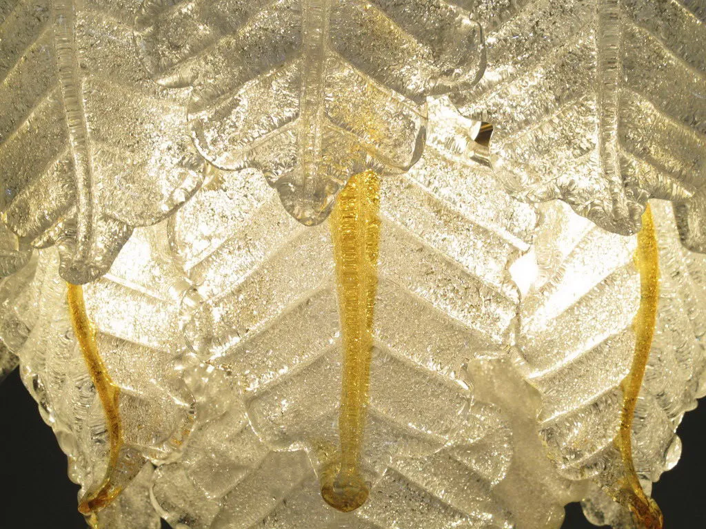 Close view of 2 antique hanging lamps with golden details, glowing.