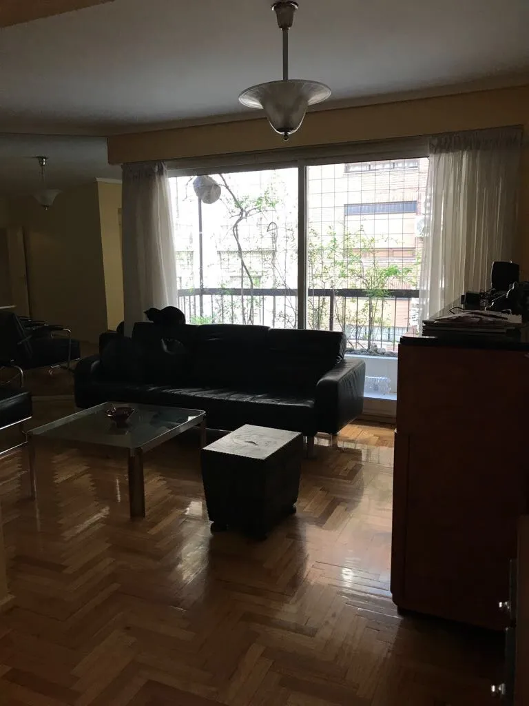 Vista de 2 lámparas de techo antiguas en una sala con sofá y mesa de centro.