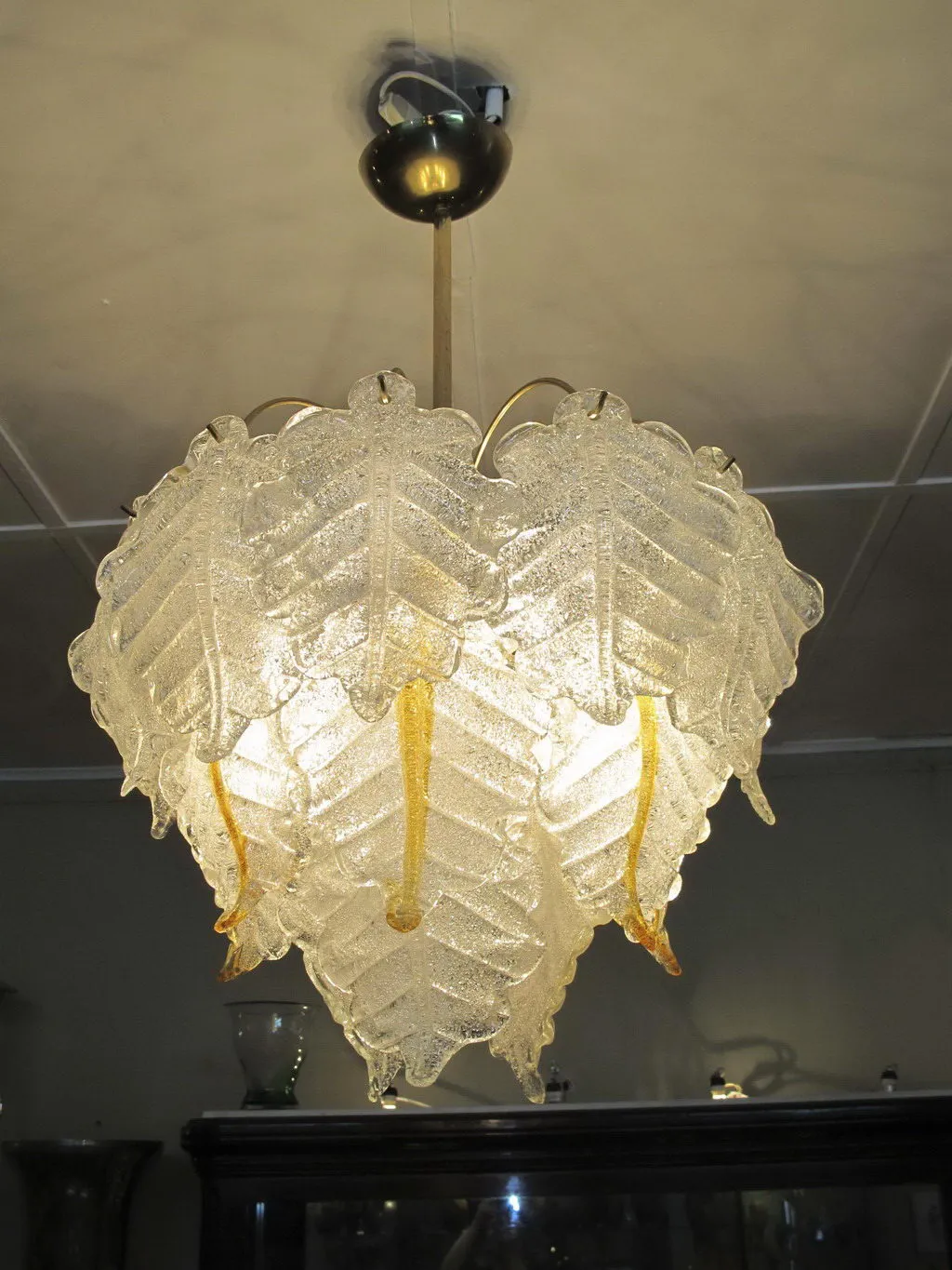 Two antique hanging lamps with an elegant design and decorative leaves in a soft environment.
