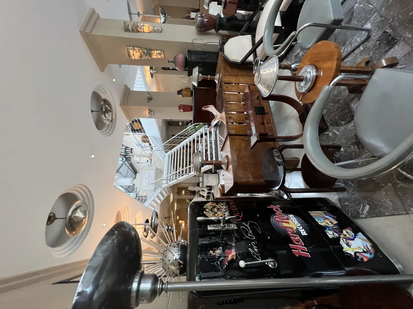 Two antique hanging lamps in an elegant indoor setting with various furniture.