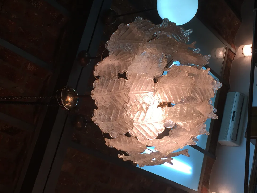 View of two antique hanging lamps with leaf design in a modern ambiance