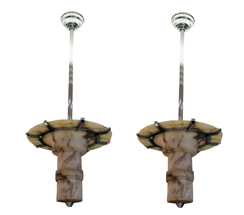 Two antique hanging lamps designed in a classic style, suspended from tall ceilings.