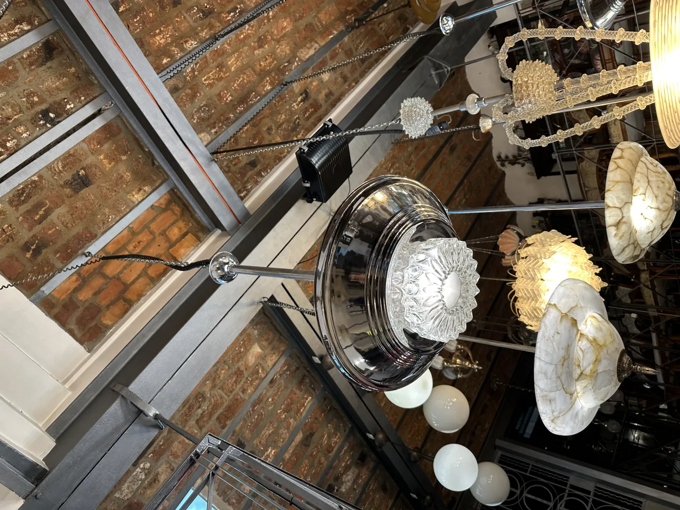 Two antique hanging lamps, showcasing varied designs in a cozy setting