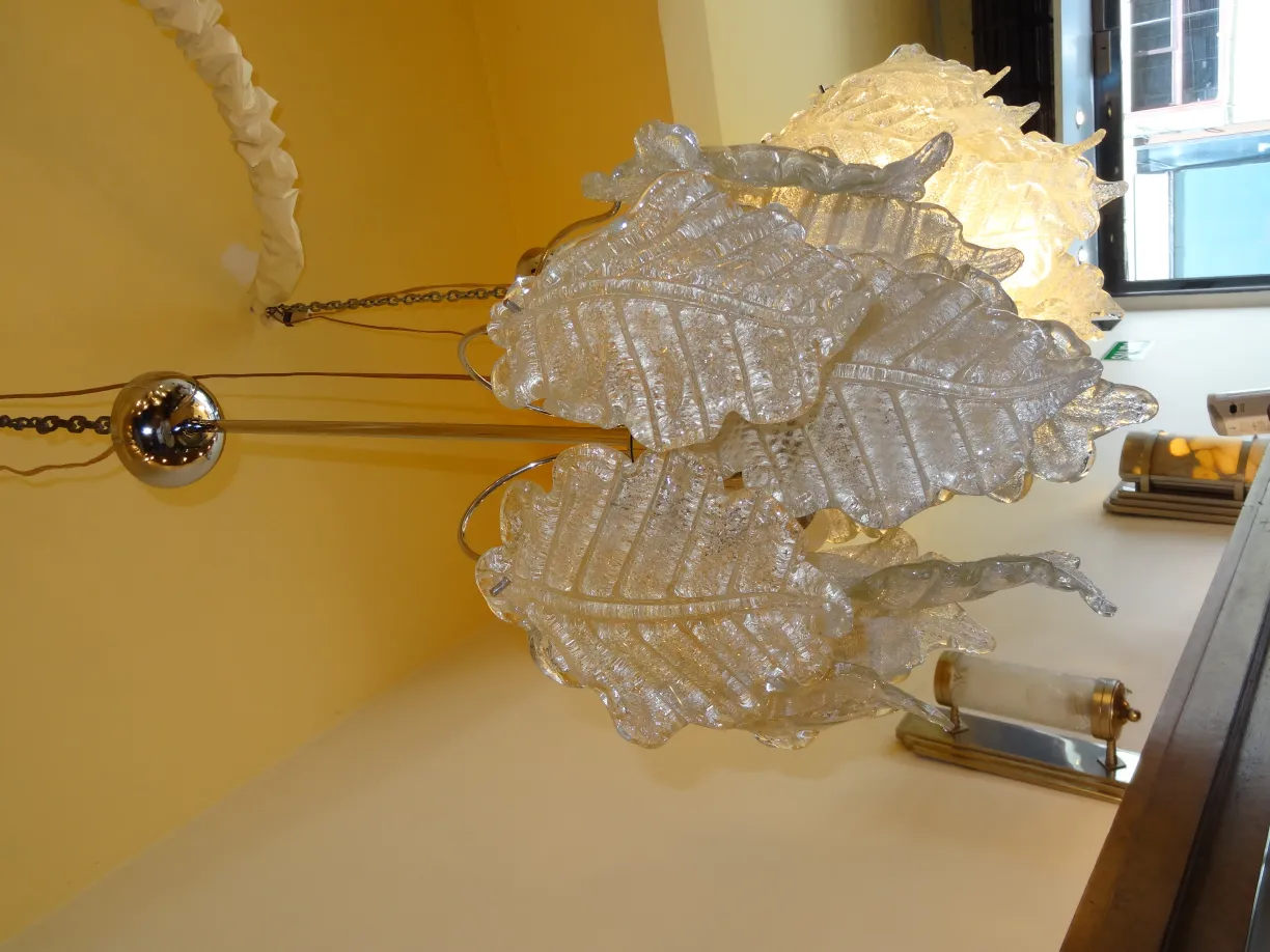 Two antique hanging lamps with leaf design, in a warm setting