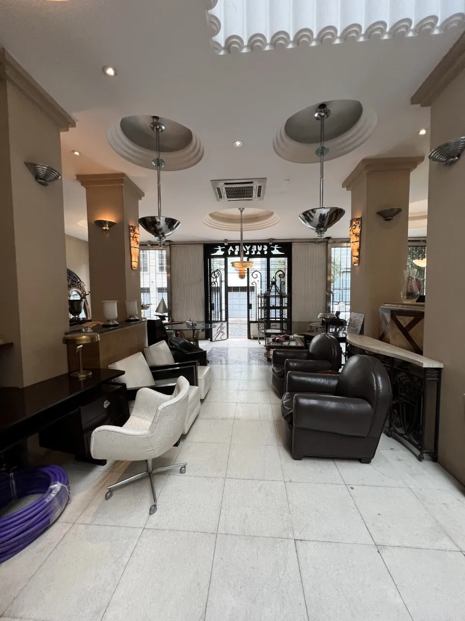 dos lámparas de techo antiguas en un ambiente elegante con sillones