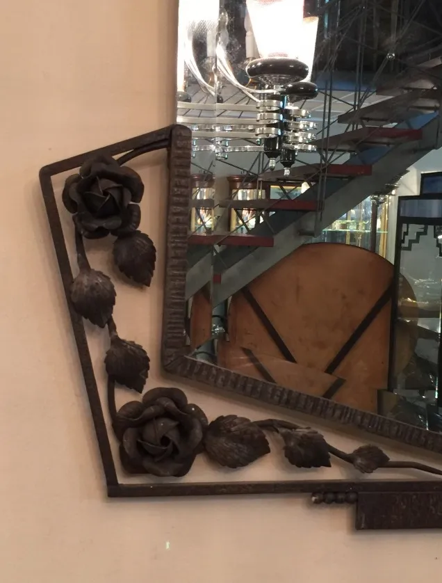 antique mirror decorated with roses on the frame