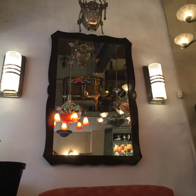 antique mirror with decorative edges and light decor