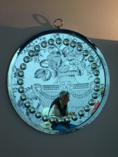 antique decorative mirror with circular border and beads