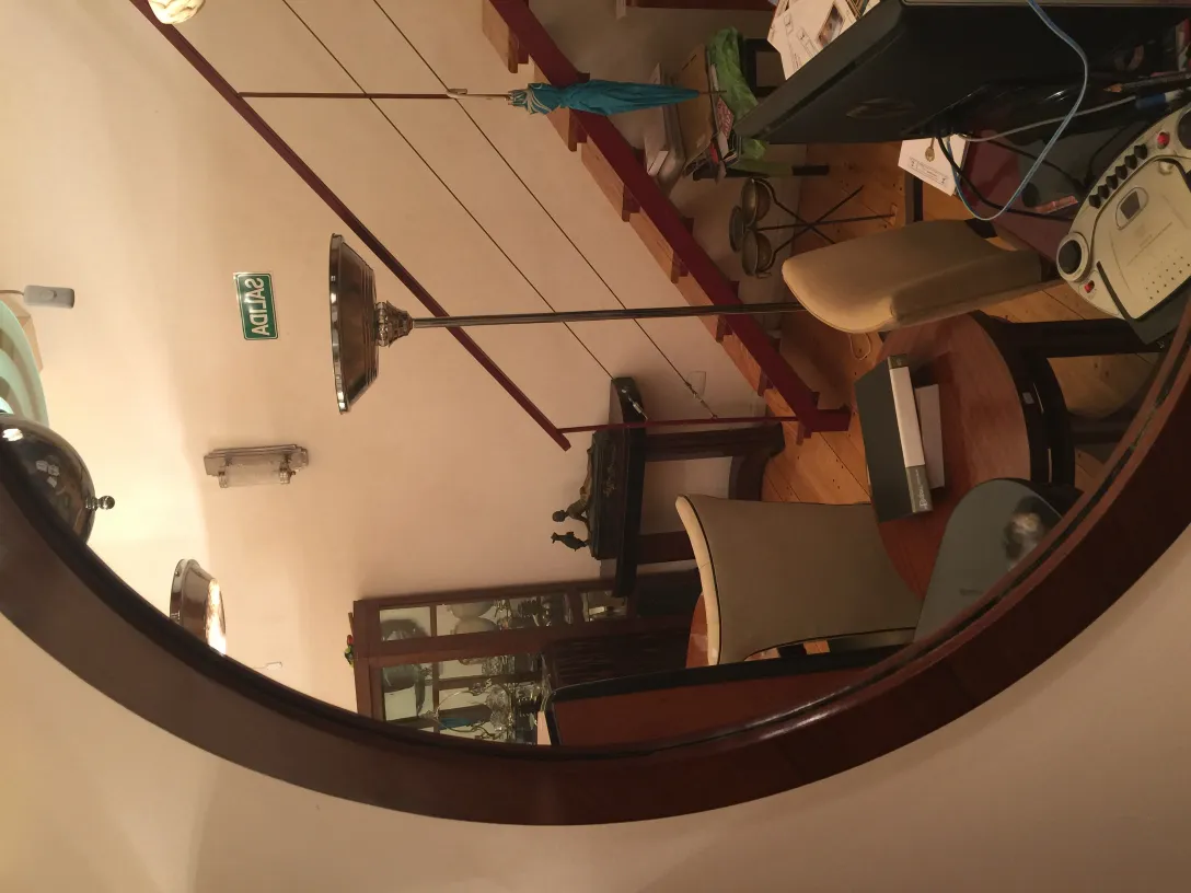 antique mirror with rounded design, decorated room