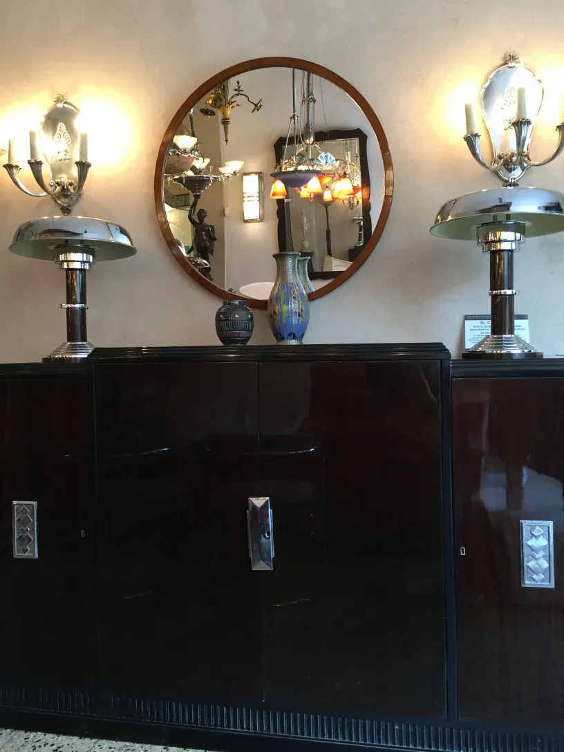 Antique round mirror with a wooden frame and classic ambiance.