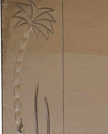 antique mirror featuring a palm tree drawing in the scene