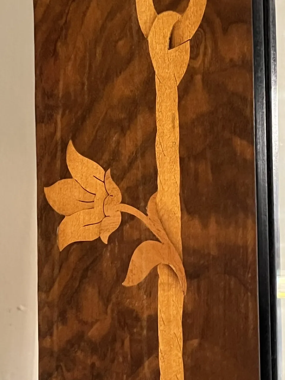 Antique decorative mirror featuring floral details in wood.