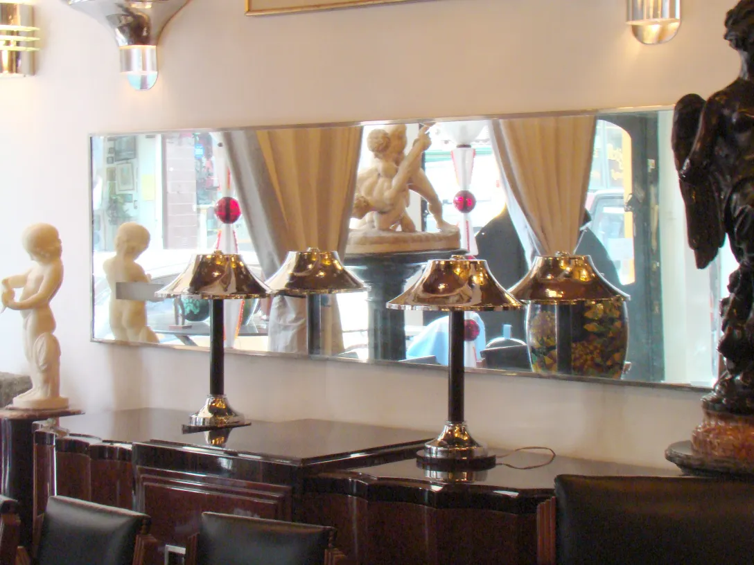 antique mirror with decoration, lamps, and sculptures