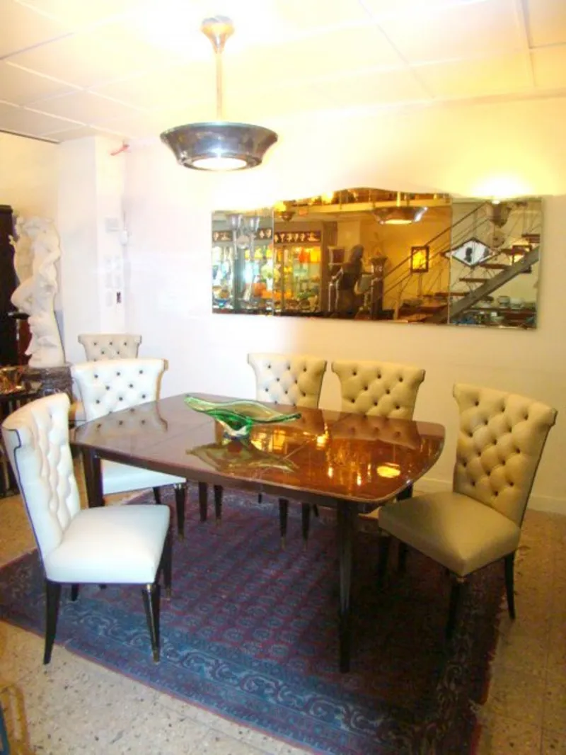 antique wall mirror in an elegant setting with chairs