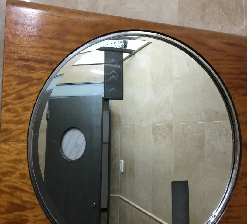 antique mirror with oval frame on a wall