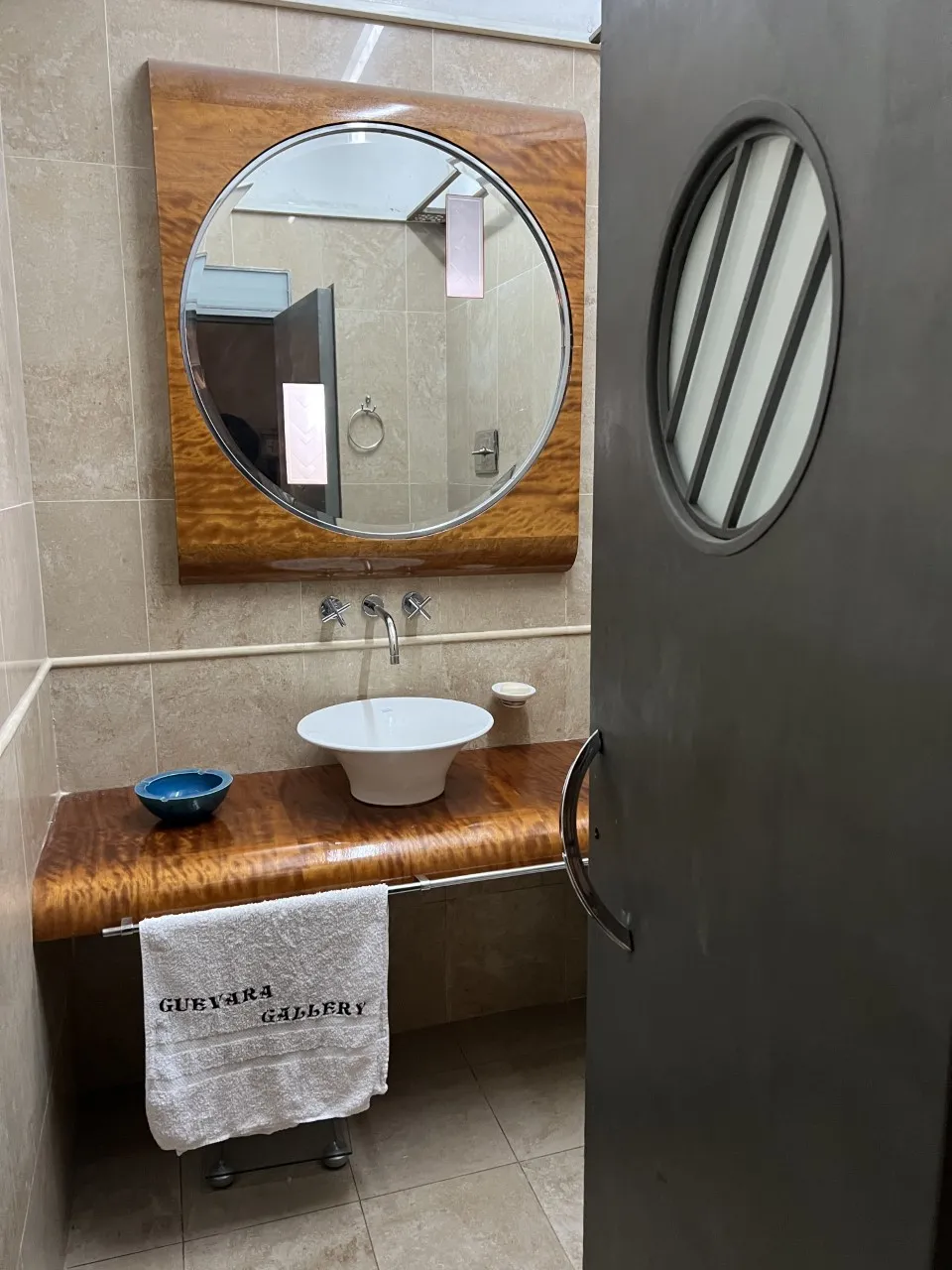 antique round mirror with an elegant design in a modern bathroom