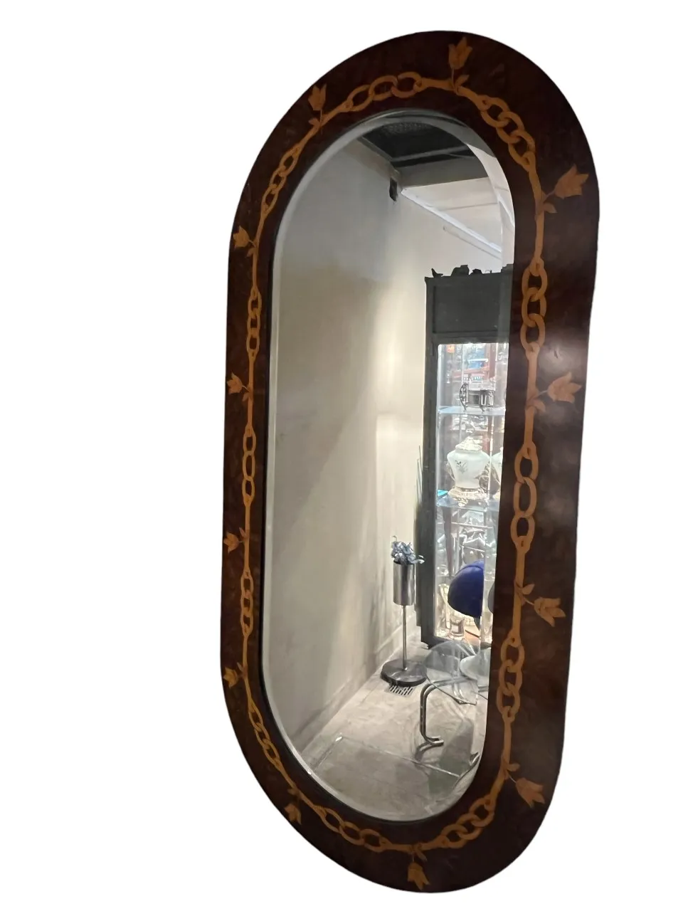 antique decorative mirror featuring a chain and leaf design