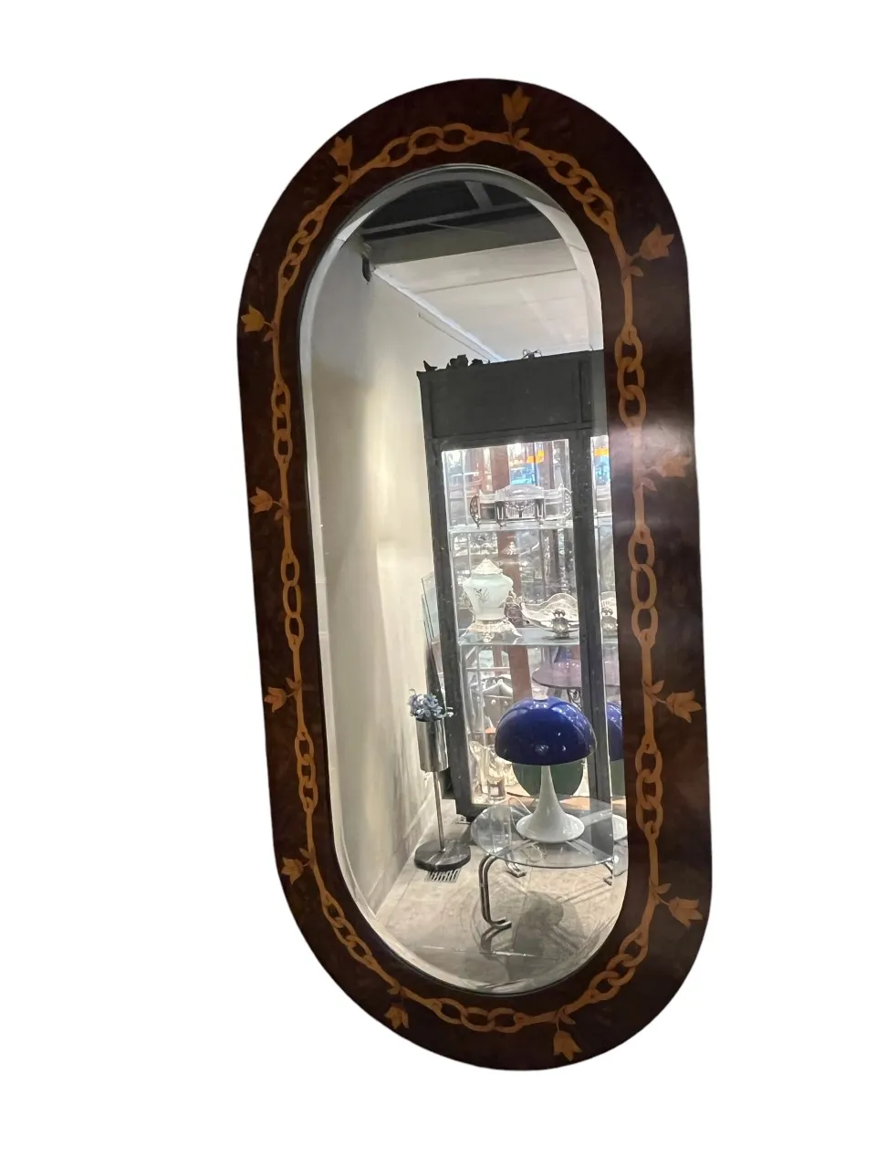 espelho antigo com decoração e objetos ao fundo