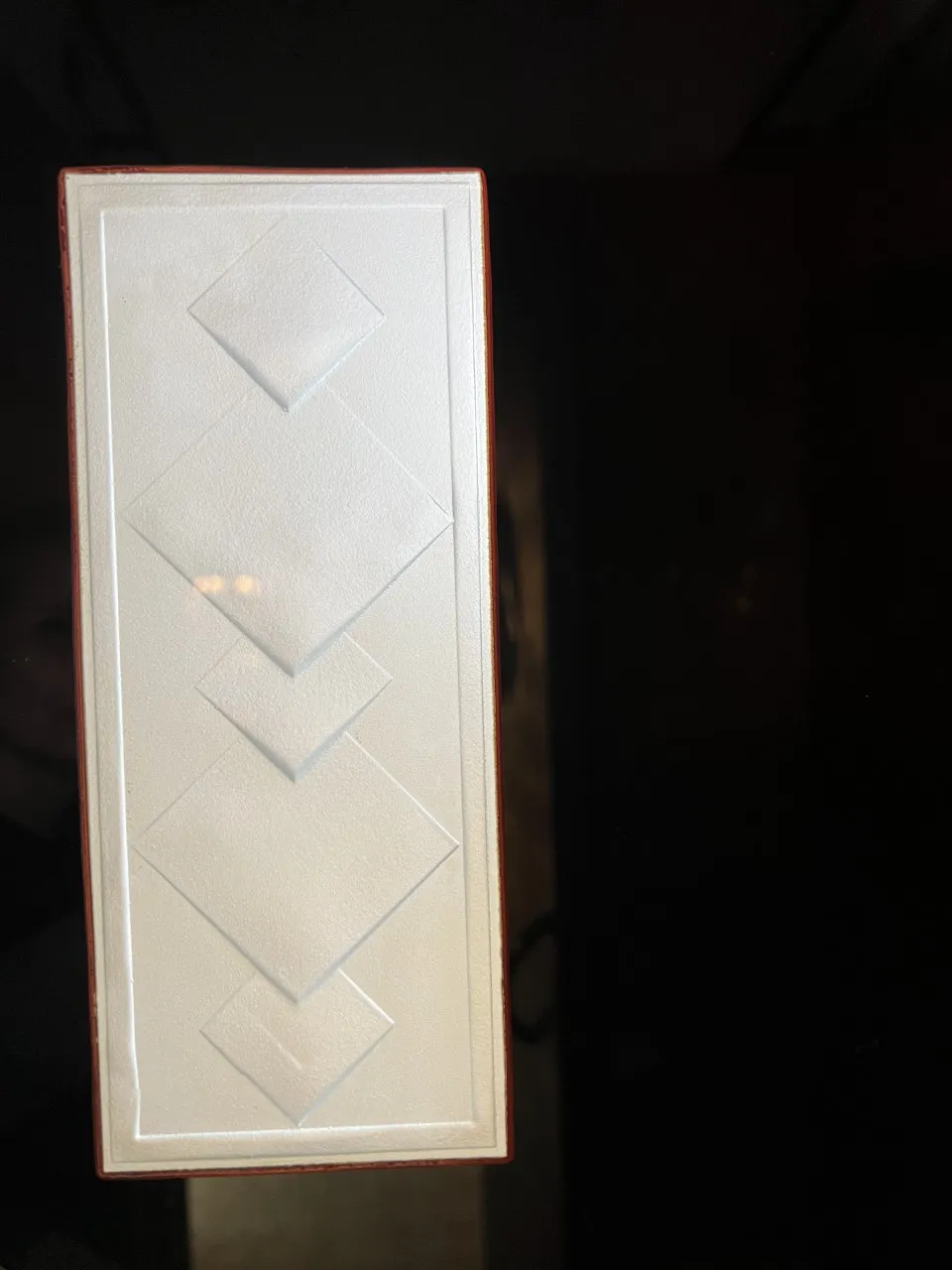 antique white mirror with raised geometric design