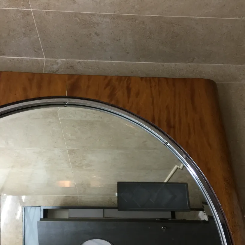 Antique round mirror with a clear edge in a modern setting.